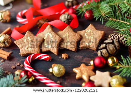 christmas cookies in the shape of stars decor gold lettering 2019, with candy,  tree and pine cones, and  balls yellow and red, Christmas 2019, new year is 2019, selective focus
