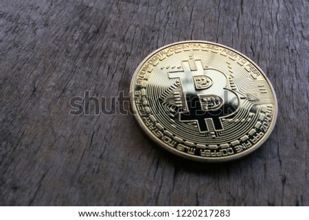 bitcoin lies on a wooden background