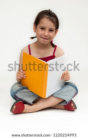 young girl reading a book isolated on white background