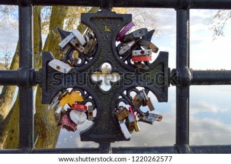A lot of barn locks hang hitched to the bridge railing. Wedding tradition to hang locks on bridges for eternal love.
