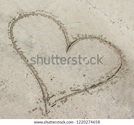 A sloppy heart symbol drawn in the sand. This photo was taken at a beach in Brighton, Australia. 