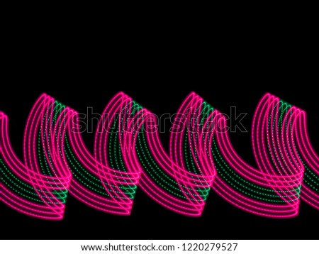 Lights painting - long exposure photography with led lights in dark background