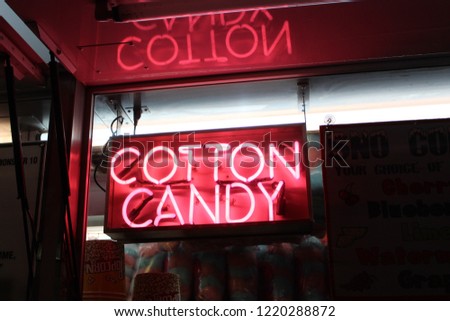 A pink neon sign from a cotton candy truck.