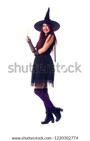 Picture of witch brunette with wine glass with wine in black dress