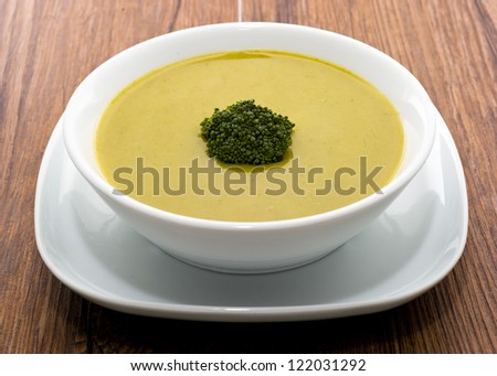 Fresh Cream of Broccoli soup isolated in wooden table