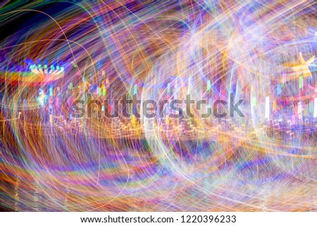 abstract image of Of the light,ong exposure fairy lights curves and waves against a black background