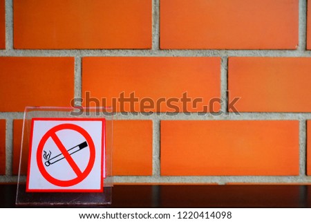 No Smoking Sign with Brick Wall Background in Coffee Shop.