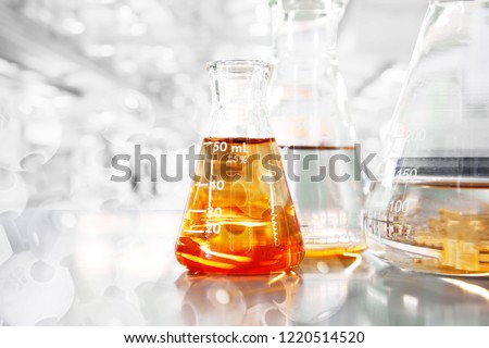 orange so in conical three flasks with chemical structure in science education laboratory background Royalty-Free Stock Photo #1220514520