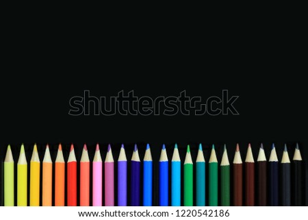 Color pencils isolated on black background with copy space.