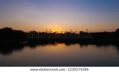 Beautiful nutural sunset over forest or lagoon. Countryside landscape in Thailand