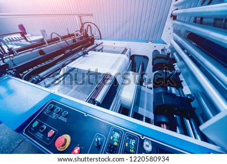 Modern automated production line in factory. Plastic bag manufacturing process. Background