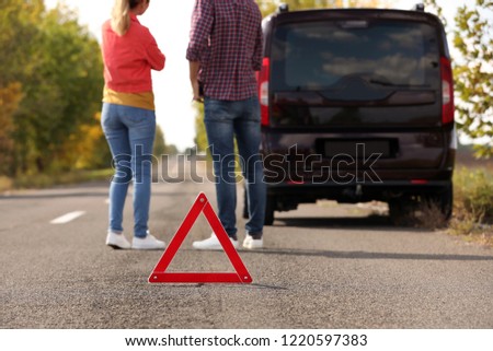 Emergency stop sign near people discussing car accident on road. Auto insurance
