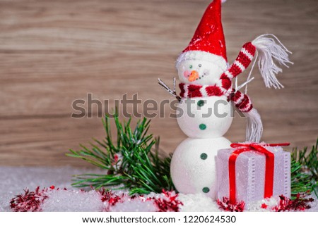 Snowmen with ornaments and gift box and abstract background.