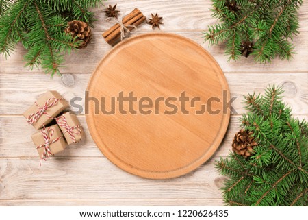 pizza cutting board at table background with christmas decoration, Round board. New Year concept.