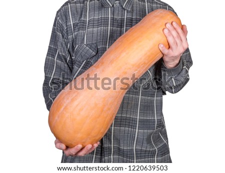 Men holds big whole ripe butternut squash in his arms on a white background
