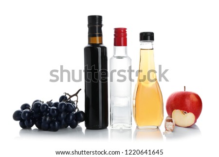 Composition with different kinds of vinegar and ingredients on white background Royalty-Free Stock Photo #1220641645