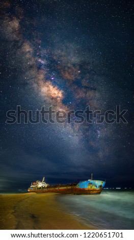 The milky way galaxy behind a sunken ship.