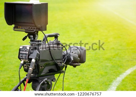 video camera put on the back of football goal for broadcast on TV sport channel. football program can't editing in studio. camera man is importance to catch moment of player.