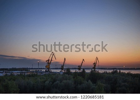 port cranes in the dock at sunset