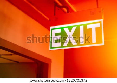 green fire exit sign light at emergency escape door