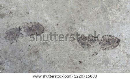 Dirty footprints on asphalt