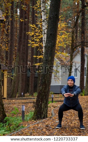 Young woman doing exercises in the fresh air. Outdoor.