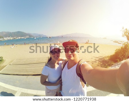 man with woman take selfie on beach sea