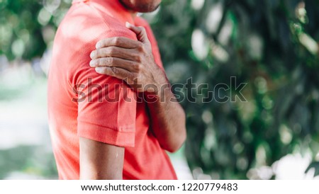  young man with shoulder pain , office syndrome ,  health care concept
