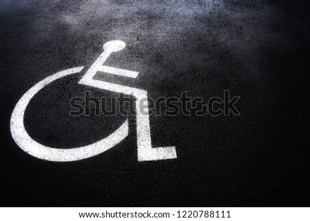 Disabled people icon or Handicap symbol on parking space.Sign design on urban asphalt road.Wheel chair logo on copy space empty blank.Disability Concept.
