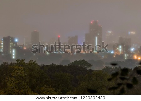 A Shot of Minneapolis High Rises Disappearing into a Gloomy Rainy Landscape at Night