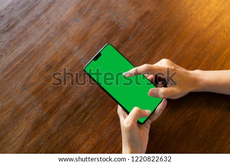green screen phone on wooden desk