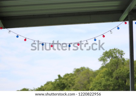 Colorful string of lights, summer day at the lake