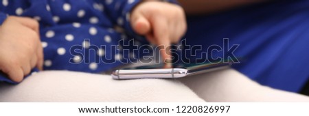 Cute little girl on floor carpet with mom use cellphone calling dad closeup. Life style apps social web network wireless ip telephony concept