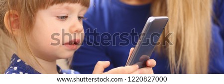 Cute little girl on floor carpet with mom use cellphone calling dad portrait. Life style apps social web network wireless ip telephony concept