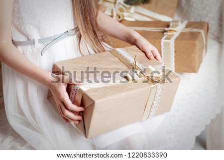 Girl's hands holding gift box. Copy space. Christmas, hew year, birthday concept.