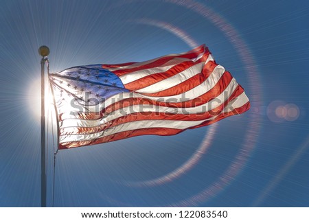 American flag waving in the wind with lens flare