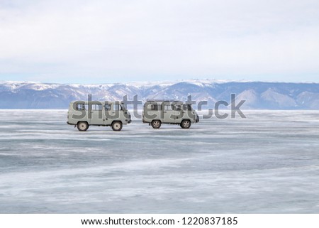 Frozen lake Baikal aerial view landscape with car driving on ice. Beautiful frozen lake landscape texture