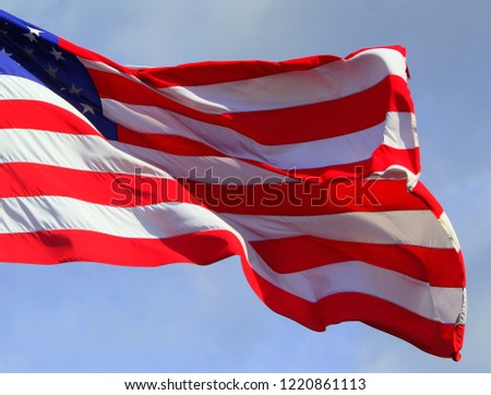 Close up isolated colorful waving rippled unfurled United states of American U.S. flag with stars and stripes red white and blue 4th of July
