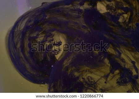 ink black in water abstract background with shiny particles. waves frozen.