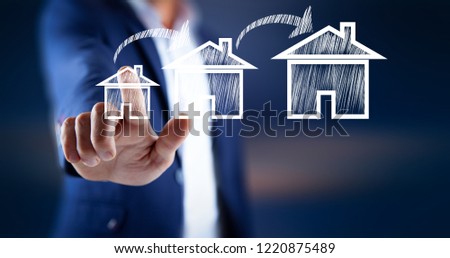 man touching house model in screen