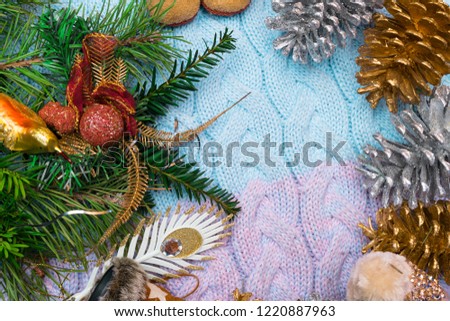 Christmas background. spruce branches, cones, toy bird on soft blancket, Workplace for preparing handmade new year decorations. Winter holidays concept. Top view.