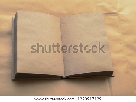 Open notebook with empty craft texture pages. Personal diary with empty pages on a brown or yellow background. A book with empty page. Top view. empty Copy space for inscription. back to school