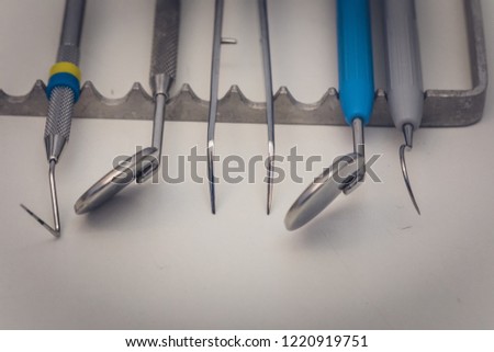 Detailed close up of different dental instruments and tools on a table, dentistry
