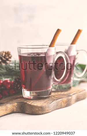 Traditional winter drink  mulled wine and Christmas decorations on white rustic background