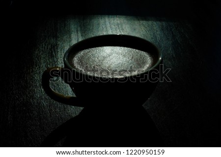 A Cup of hot latte art coffee on wooden table and window light in Morning, coffee with perfect leaf shape latte art, Lowkey light 