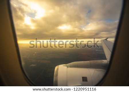Traveling concept,Looking through the window, a morning sunrise with the wing of the airplane,copy space for add text.