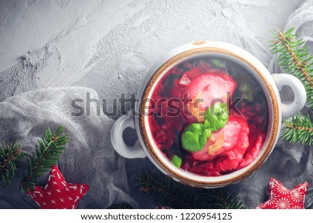 Red borscht with dumplings on a Christmas table. Place for text