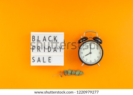 Creative Top view flat lay promotion composition Black friday sale text on lightbox alarm clock orange background copy space Template Black friday sale mockup fall thanksgiving promotion advertising