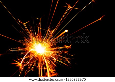 burning wire sparkler on black background