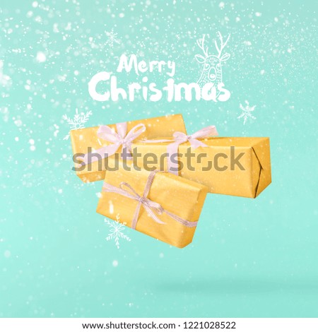 Christmas concept.  Creative Christmas conception made by falling in air gift box over turquoise background. Minimal concept